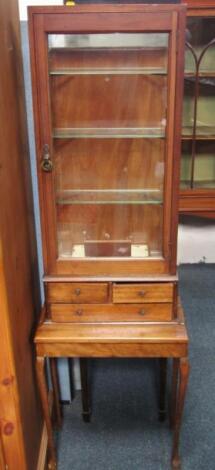 An Edwardian mahogany and oak shop display cabinet on stand