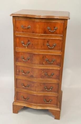 A yew wood serpentine chest of six drawers