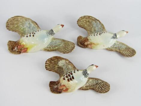 A set of three Beswick graduated pottery Partridge wall plaques