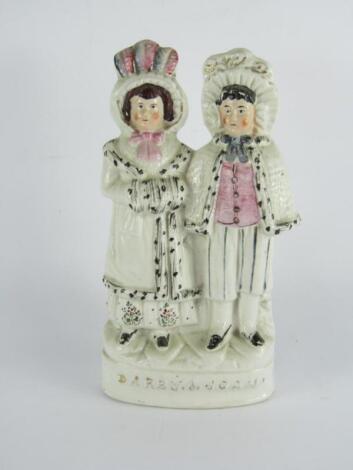 A Staffordshire late 19thC pottery figure group modelled as Darby & Joan