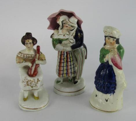 A Staffordshire early 19thC porcelain figure of lovers kissing under an umbrella