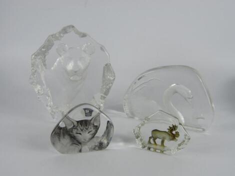 Two Mats Jonasson intaglio glass paperweights of a lioness and swan