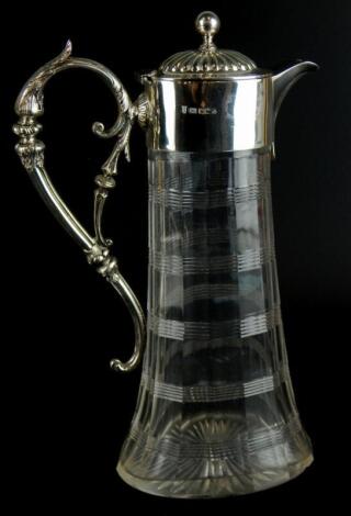An Edwardian cut glass and silver mounted claret jug