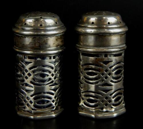 A pair of Edwardian silver pepper pots