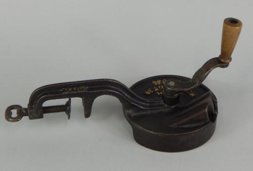 An early 20thC spong cast iron bean slicer