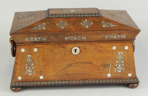 An early Victorian rosewood and mother of pearl inlaid sarcophagus shaped tea caddy