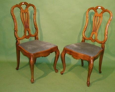 A pair of early 20thC Continental walnut side chairs with pierced vase splats