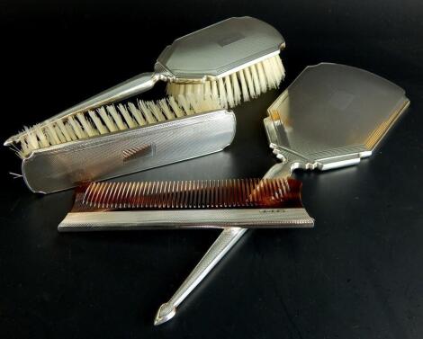 An associated engine turned silver four piece dressing table set