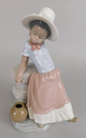 A Lladro porcelain figure of a young black girl