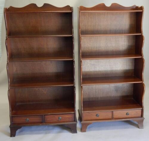 A pair of reproduction waterfall shaped bookcases