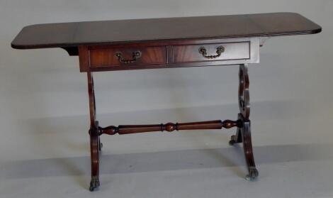 A reproduction Regency style mahogany and ebony strung sofa table