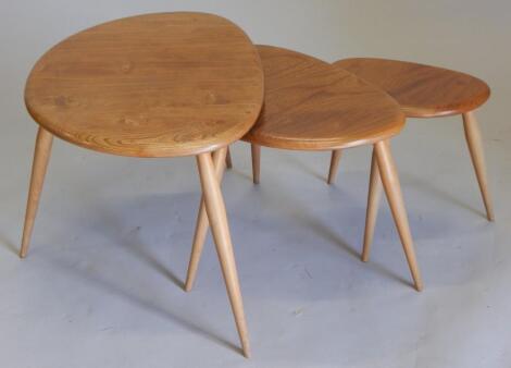 A nest of three Ercol light elm pebble shaped tables