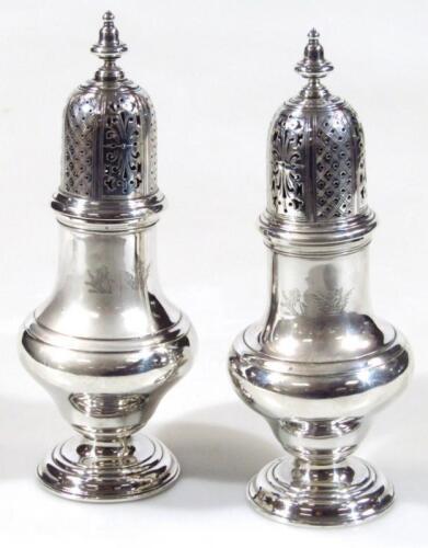 A pair of near matching Edwardian silver heavy sugar sifters