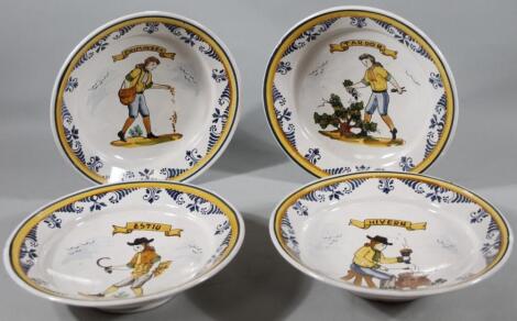 A set of four Spanish faience tin glazed earthenware plates