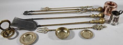 An early 20thC brass fireside companion set