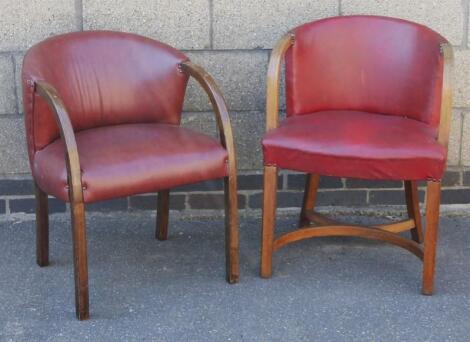 A near matching pair of oak stained tub chairs