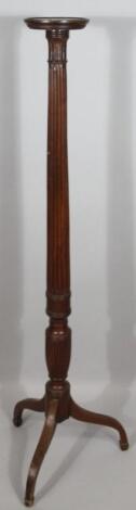 An early 20thC mahogany torchere