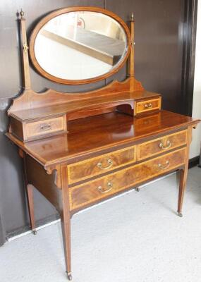 An Edwardian Sheraton Revival mahogany and boxwood strung mirror backed dressing table