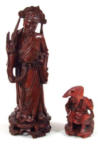 A Chinese hardwood figure of a gentleman standing holding sceptre and book