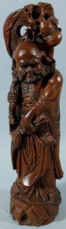 A heavily carved Chinese hardwood figure of a bearded sage