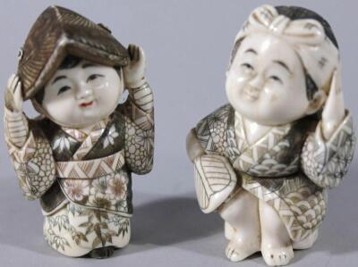 A pair of Japanese Fukusuke good fortune figures