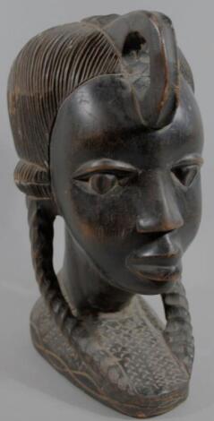 A 20thC heavily carved ebony African tribal figural head