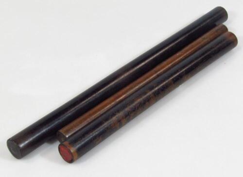 A cylindrical ebonised stick
