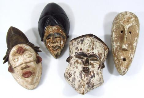 Four various carved African tribal hardwood face masks