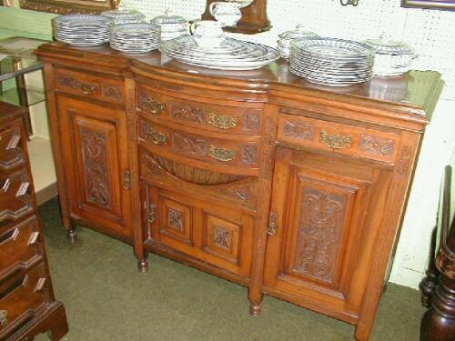 A late Victorian carved walnut dresser base