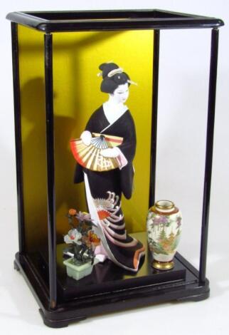 A modern ebonised oriental display cabinet