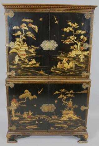 A two sectional English oriental design lacquered blanket cupboard