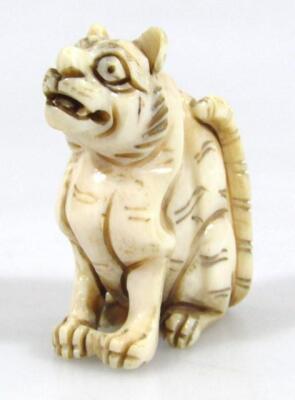 A Japanese Meiji period ivory figure of a wild cat