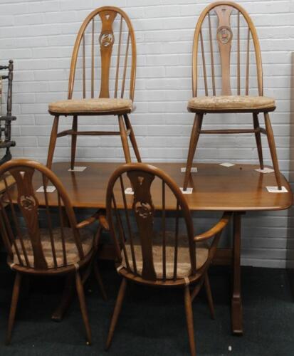 An Ercol mid coloured elm rectangular kitchen table