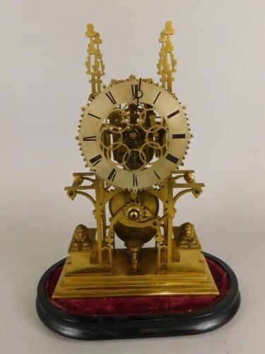 An unusual brass skeleton timepiece