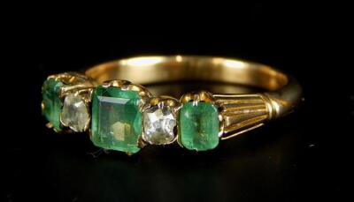 An emerald and diamond ring