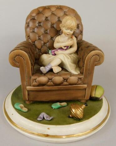 A Capodimonte bisque porcelain figure of a young girl with her doll