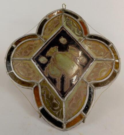 A stained glass panel of quatrefoil form