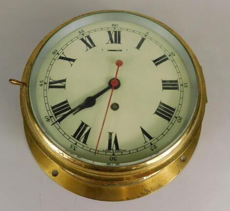 A mid 20thC brass cased ship's bulkhead clock