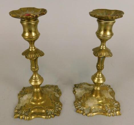 A pair of 19thC cast brass candlesticks