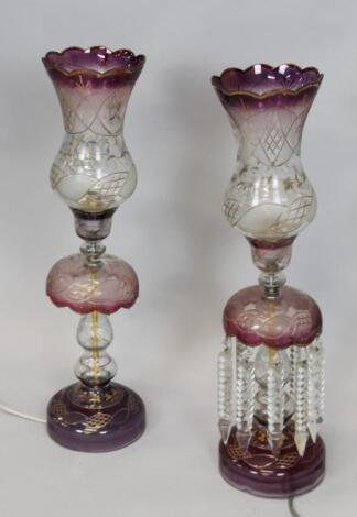 A pair of cranberry tinted glass sectional table lamps