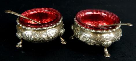 A pair of Victorian embossed silver open salt cellars