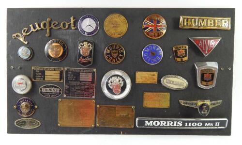 A collection of rare car badges and chassis plates