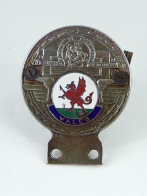 A Wales cast metal and enamel car badge