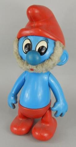 A novelty battery operated large Smurf figure