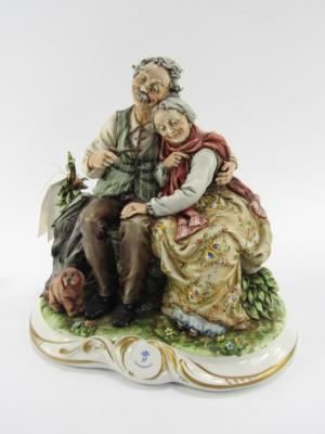 A Capodimonte porcelain figure group of an elderly couple