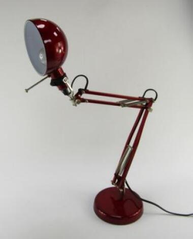 A red metal anglepoise lamp