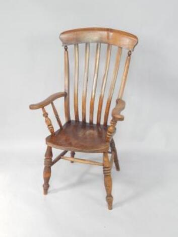 A 19thC oak and elm lath back kitchen armchair