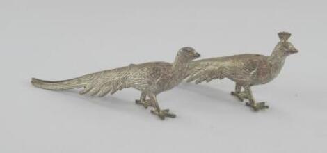 A pair of plated menu holders modelled as pheasants