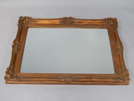 A rococo style gilt composite rectangular wall mirror