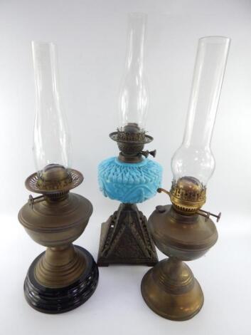 A Victorian cast iron and turquoise opaline glass oil lamp